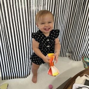 My daughter holding up a completed coin purse. Click to access gallery page.